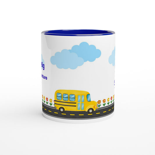 A white ceramic mug with a blue interior, featuring a cartoon illustration of a yellow school bus on a road with blue clouds and small flowers.