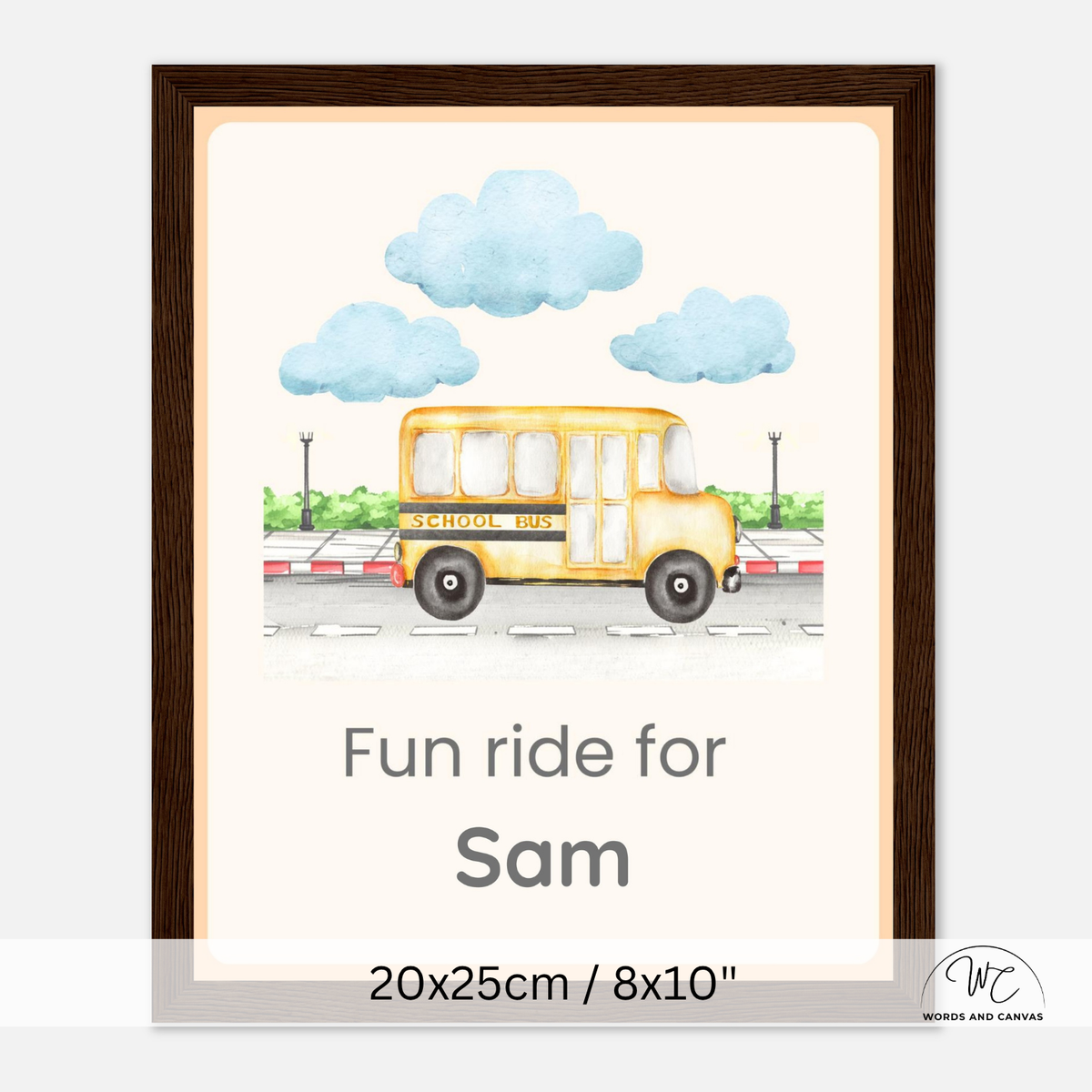A dark wooden framed personalized children's wall art print featuring a watercolor-style yellow school bus under blue clouds, with the text 'Fun ride for Sam' and size text '20x25cm / 8x10"' at the bottom.