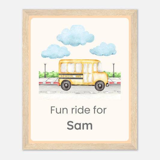 A personalized framed art print featuring a watercolor illustration of a yellow school bus with the text 'Fun ride for Sam' underneath, enclosed in a light wood frame.