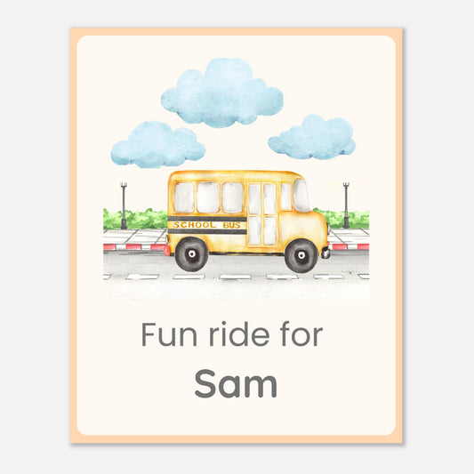 A personalized children's art print featuring a watercolor illustration of a yellow school bus under light blue clouds, with the text 'Fun ride for Sam' below. The print has a cream background, a peach border, and is shown against a light gray background.