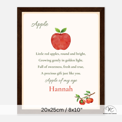A framed personalized apple-themed nursery print with a watercolor red apple illustration, poem text, and the name 'Hannah' in red script. The print is shown in a dark brown wooden frame on a light gray background, with dimensions '20x25cm / 8x10"' printed below.
