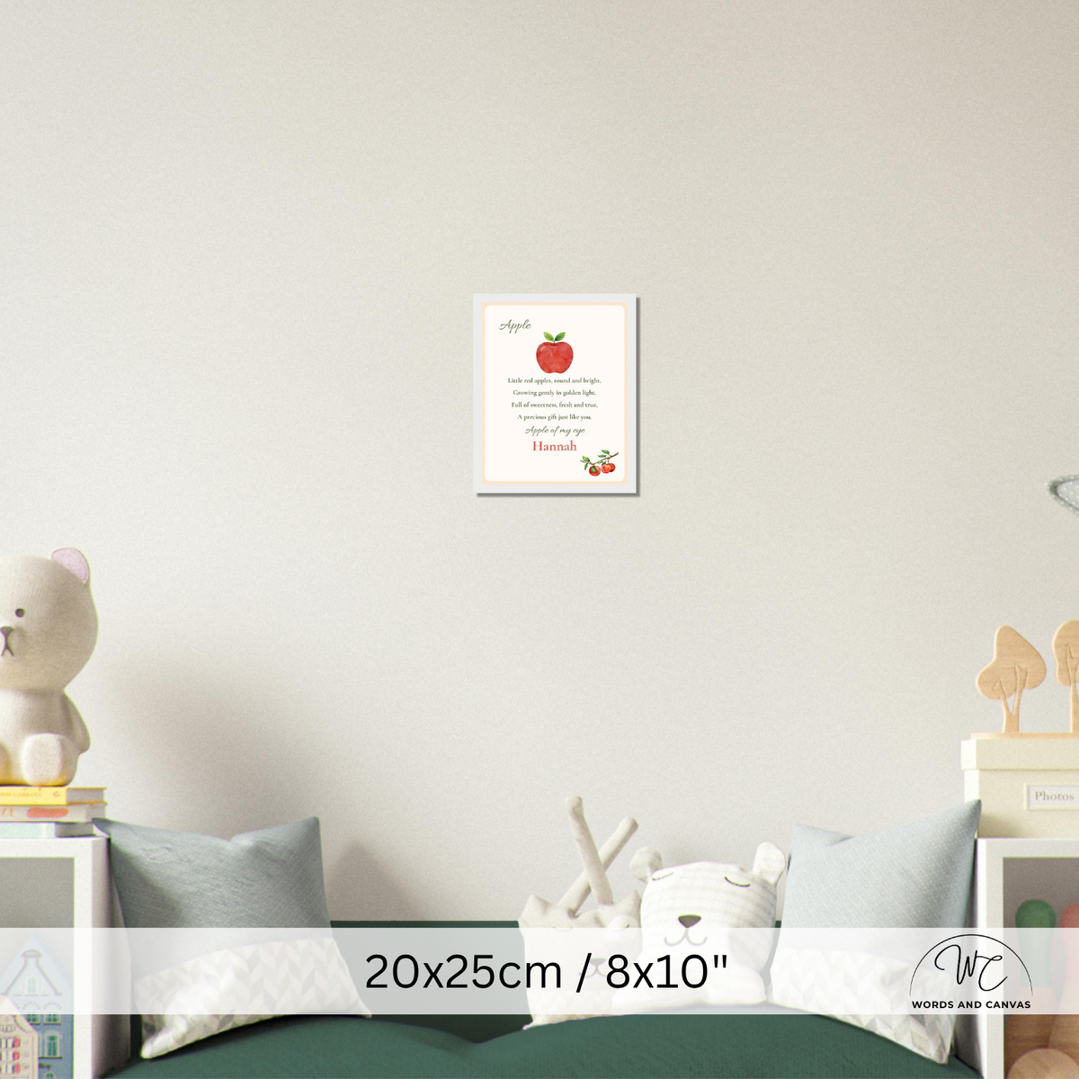 A personalized children's nursery wall art print featuring a red apple and poem displayed on a light gray wall above a bed with toys and pillows. A white banner at the bottom displays the dimensions '20x25cm / 8x10"' and a watermark logo for 'Words and Canvas'.