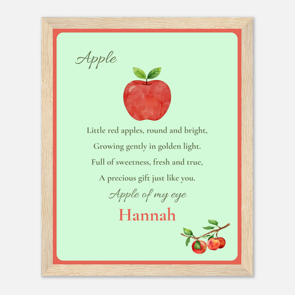 A framed nursery wall art with a watercolour apple, poem and name
