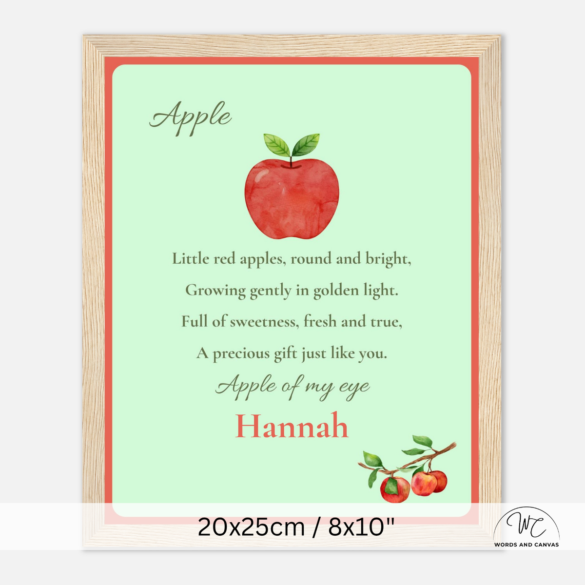 Personalized wooden-framed apple nursery sign with a light green background, red apple illustration, nursery rhyme text, and the name Hannah in red at the bottom. Shown on a white background with size text below.