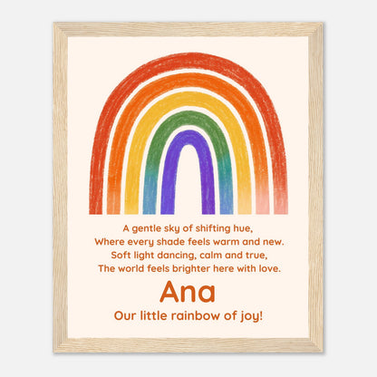 A personalized framed art print featuring a colorful rainbow and a nursery rhyme. The print has a cream background with a hand-drawn style rainbow in red, orange, yellow, green, blue, and purple.