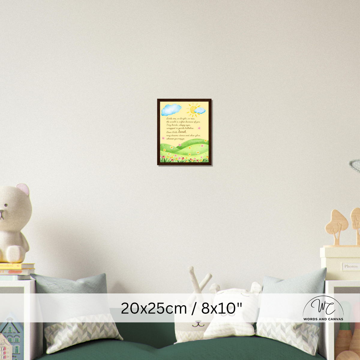 A framed children's  print with a colorful landscape illustration is displayed on a light gray wall above a green sofa in a styled room. 