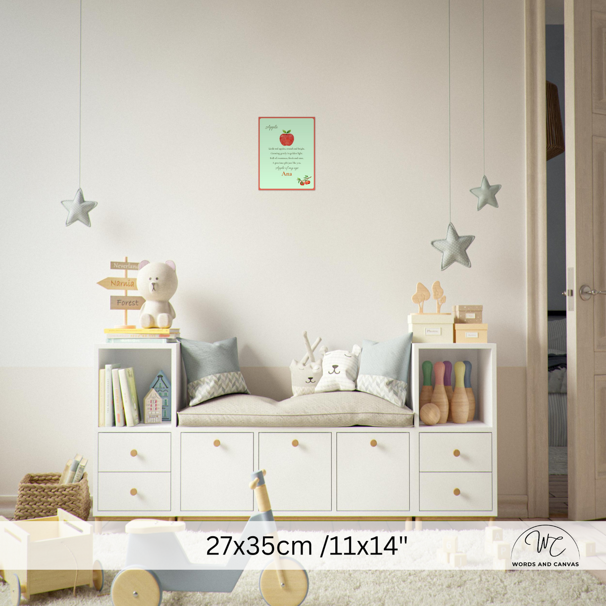 A nursery room scene showing a white children's storage bench with open shelves and drawers, styled with toys, pillows, books, and hanging star decorations. A small framed print hangs on the wall, and a size overlay at the bottom reads 27x35cm / 11x14 inches.