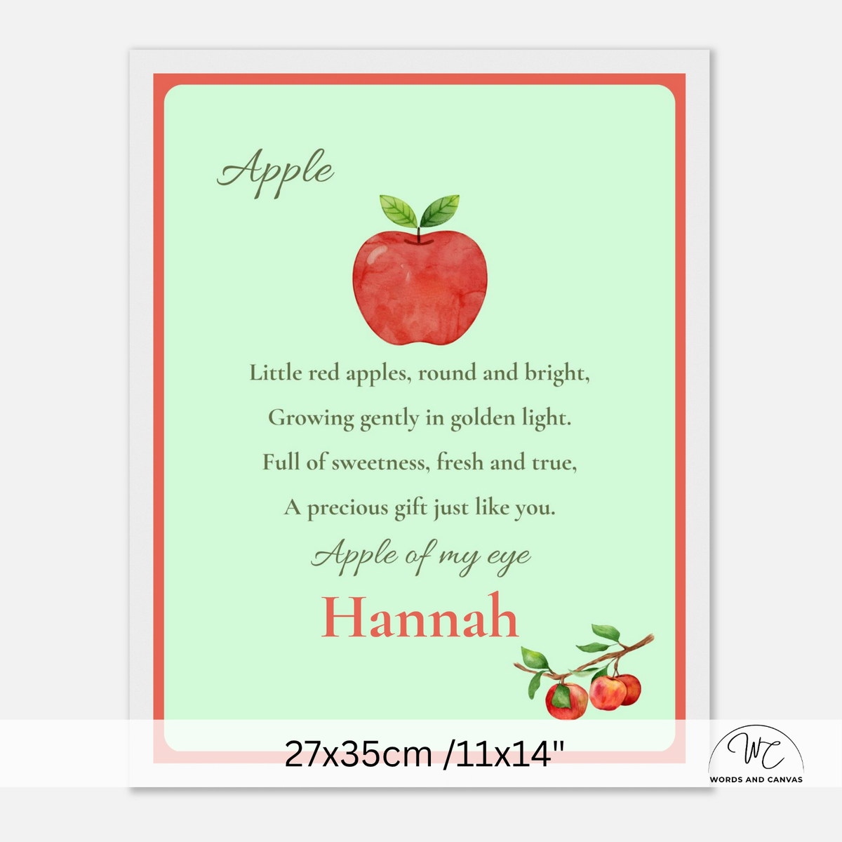 A personalized apple-themed nursery or children's poster with a light mint green background, a red watercolor apple illustration, and printed text including the name Hannah. The white framed wall print is shown centered on a light gray background with a size note at the bottom.