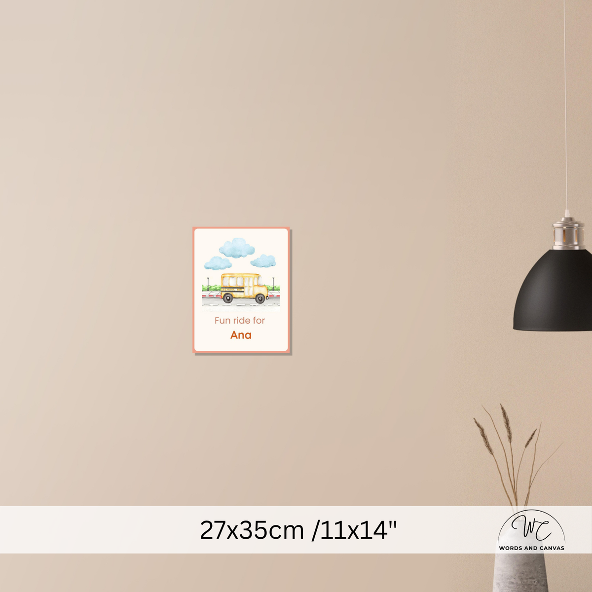 A framed personalized wall art print featuring a yellow school bus and clouds with the text 'Fun ride for Sam', displayed on a beige wall in a styled room scene with a black pendant light and dried grass decor. The bottom includes a size label '27x35cm /11x14"' and a 'Words and Canvas' logo.