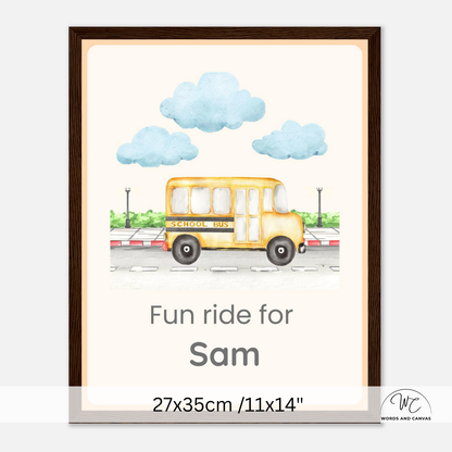 A framed personalized children's wall art print featuring a yellow school bus illustration, blue clouds, and the text 'Fun ride for Sam' with size text '27x35cm /11x14"' at the bottom. The print is shown in a dark brown frame against a light gray background.
