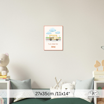 A personalized children's wall art print featuring a yellow school bus and blue clouds with the text 'Fun ride for Ana', displayed on a light gray wall above a bed in a styled bedroom setting. A size overlay at the bottom reads 27x35cm / 11x14".