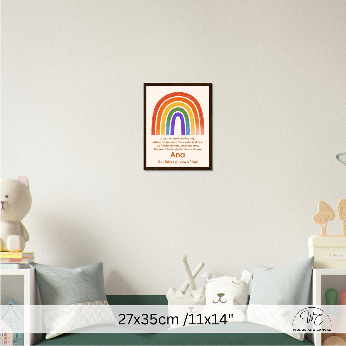 A framed personalized rainbow art print hangs on a light gray wall above a bed in a styled bedroom. 