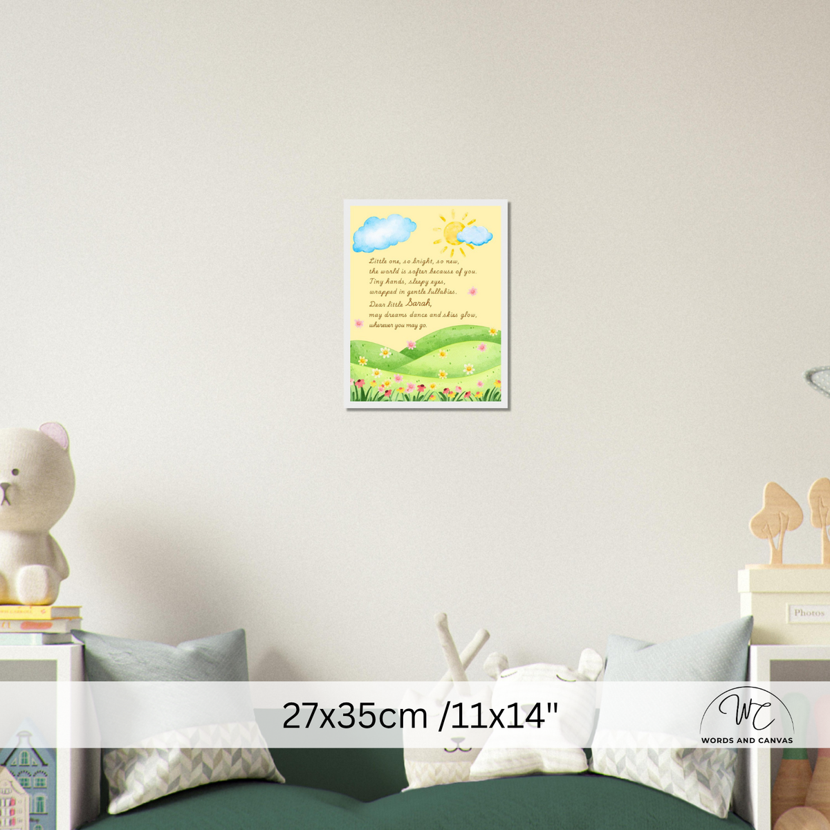 A framed nursery wall art print featuring a yellow sun, blue clouds, green hills, and a poem, displayed on a light gray wall above a bed. A size overlay reads 27x35cm / 11x14".