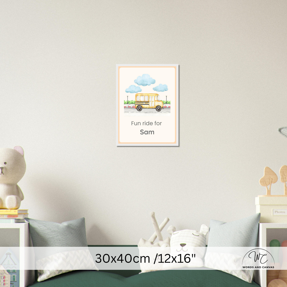 A personalized children's wall art print featuring a yellow school bus and blue clouds with the text 'Fun ride for Sam', displayed on a light gray wall above a bed in a styled bedroom setting.