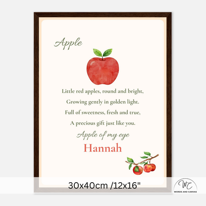 A personalized framed apple-themed nursery print featuring a watercolor red apple with green leaves and the nursery rhyme text 'Apple of my eye' with the name 'Hannah' in red. The print is shown in a dark brown wooden frame against a light gray background with a dimension 30x40cm overlay at the bottom.