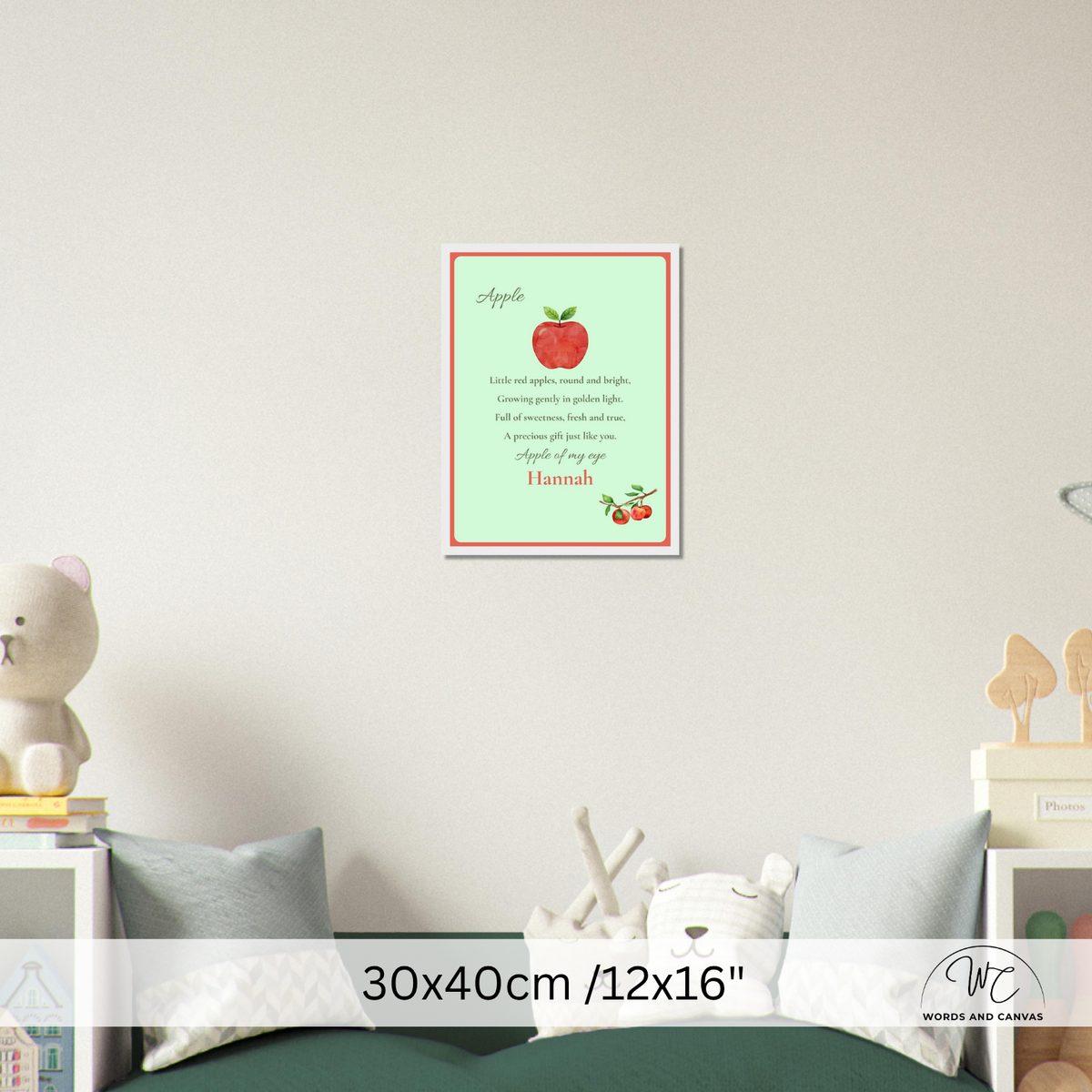 A framed apple-themed nursery wall print hanging above a bed in a styled bedroom scene. The print has a pale green background with a red apple illustration, poem, and a red border.