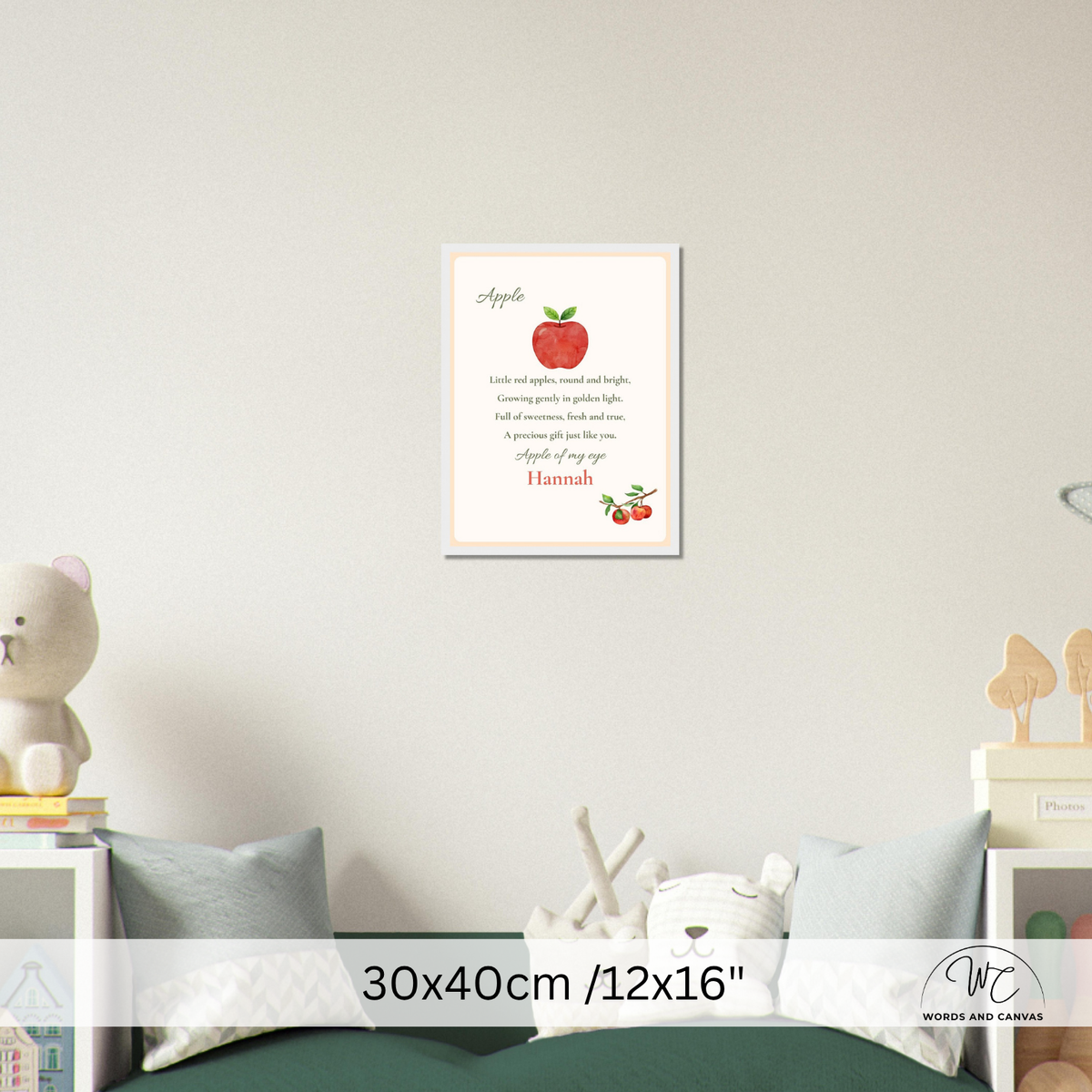 A personalized apple-themed nursery wall print with a red apple illustration and text, shown hanging on a light gray wall above a bed in a styled bedroom scene. A size overlay at the bottom reads 30x40cm /12x16".