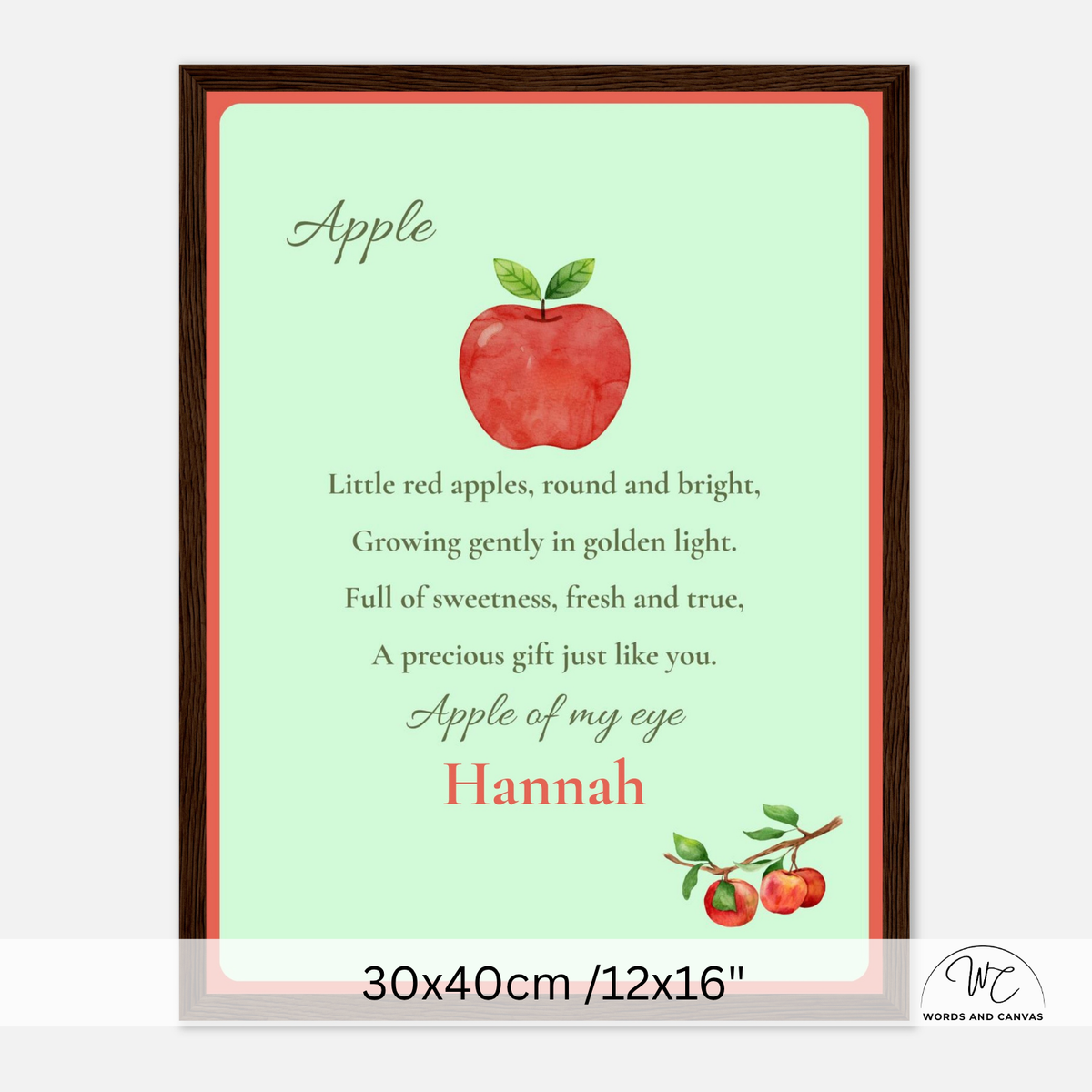 A framed personalized apple-themed nursery print with a watercolor red apple illustration, poem and the text 'Apple of my eye Hannah' on a mint green background, shown with a white background and size text at the bottom.