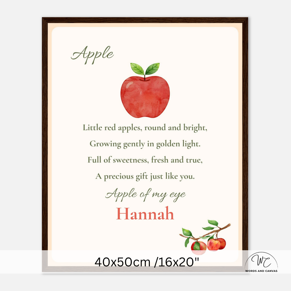 Personalized framed apple nursery wall art featuring a watercolor red apple, green text, and the name 'Hannah' on a cream background, shown in a dark brown frame with size text at the bottom.
