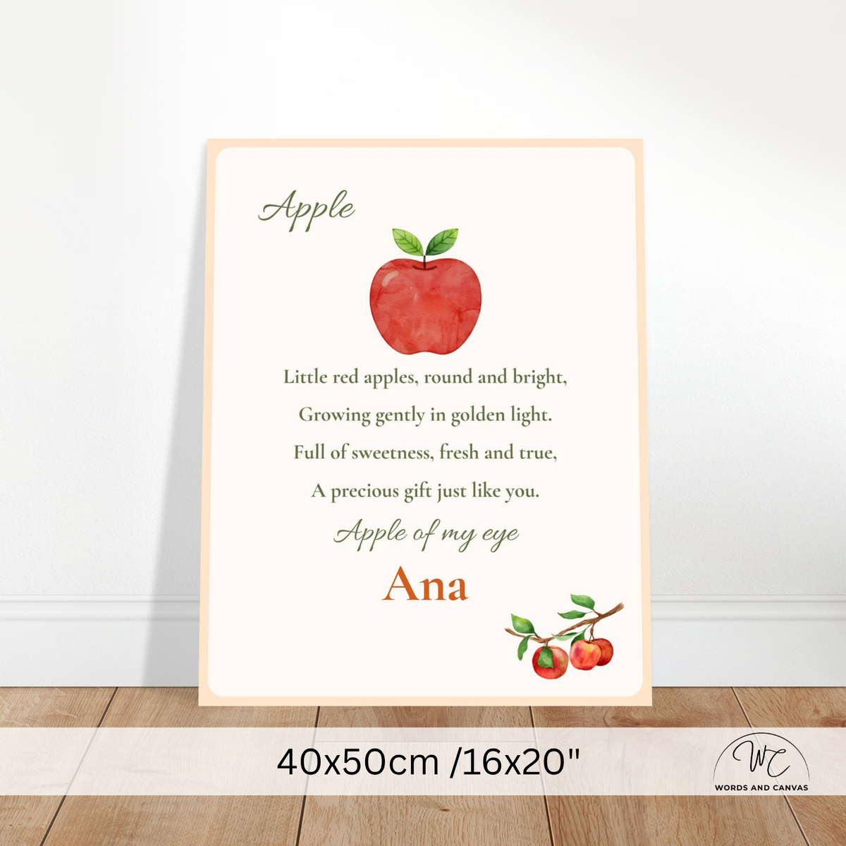 Personalized nursery wall art print featuring a watercolor red apple, a poem about apples, and the name 'Ana' at the bottom, shown leaning against a white wall on a wooden floor. A size banner at the bottom reads 40x50cm / 16x20 inches.