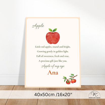 Personalized nursery wall art print featuring a watercolor red apple, a poem about apples, and the name 'Ana' at the bottom, shown leaning against a white wall on a wooden floor. A size banner at the bottom reads 40x50cm / 16x20 inches.