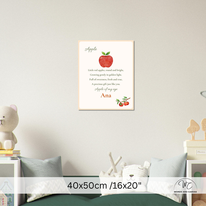 A personalized children's nursery wall art print featuring a red apple, a poem about apples, and the name 'Ana' at the bottom, displayed on a light gray wall above a bed in a styled nursery room.
