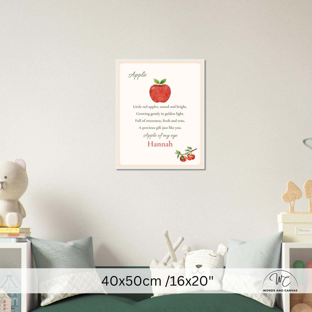 A personalized children's nursery wall art print featuring a red apple illustration and a poem titled 'Apple' with the name 'Hannah' at the bottom, displayed on a light beige wall above a bed in a styled bedroom scene.
