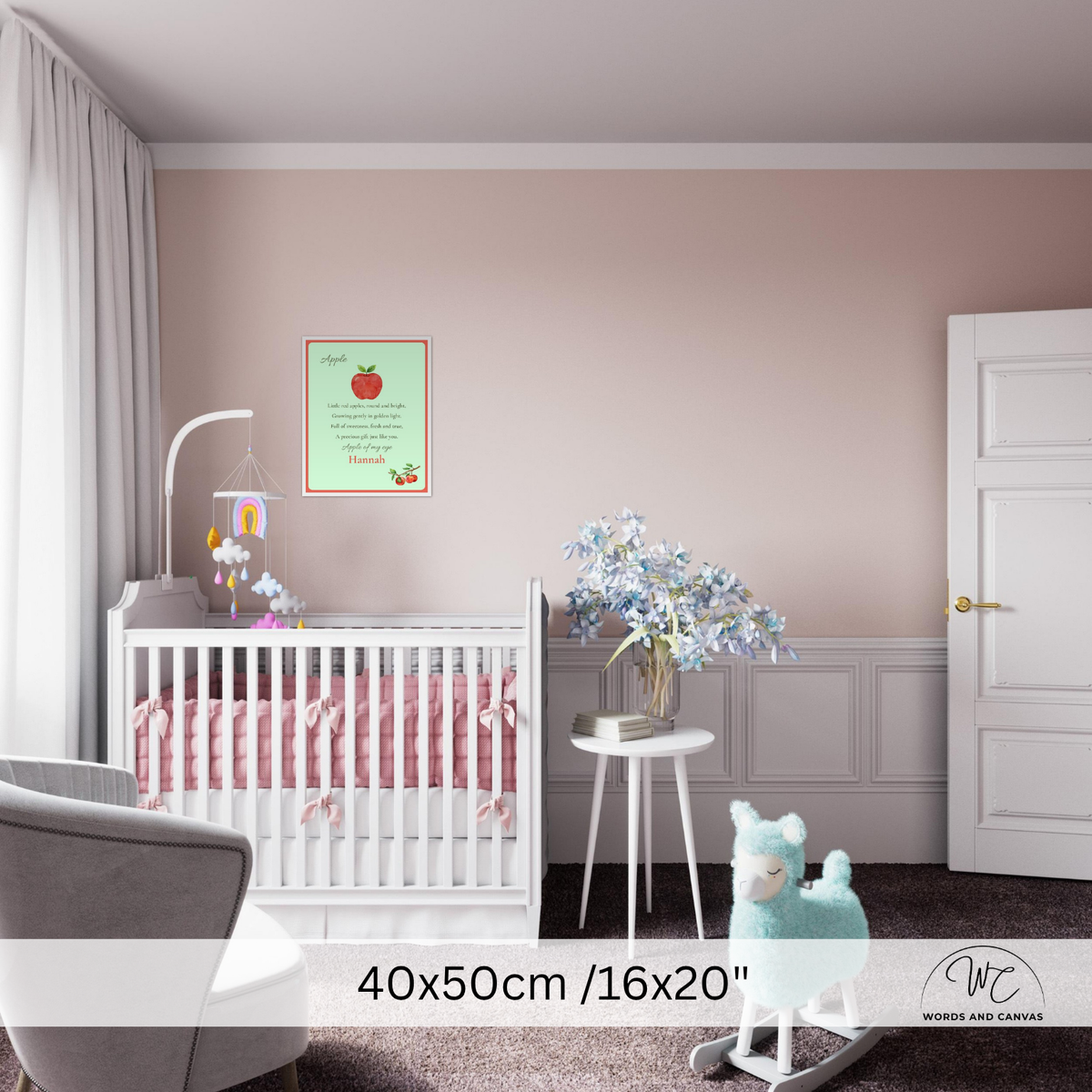 A nursery room scene showing a framed nursery art print on a dusty pink wall above a white crib.
