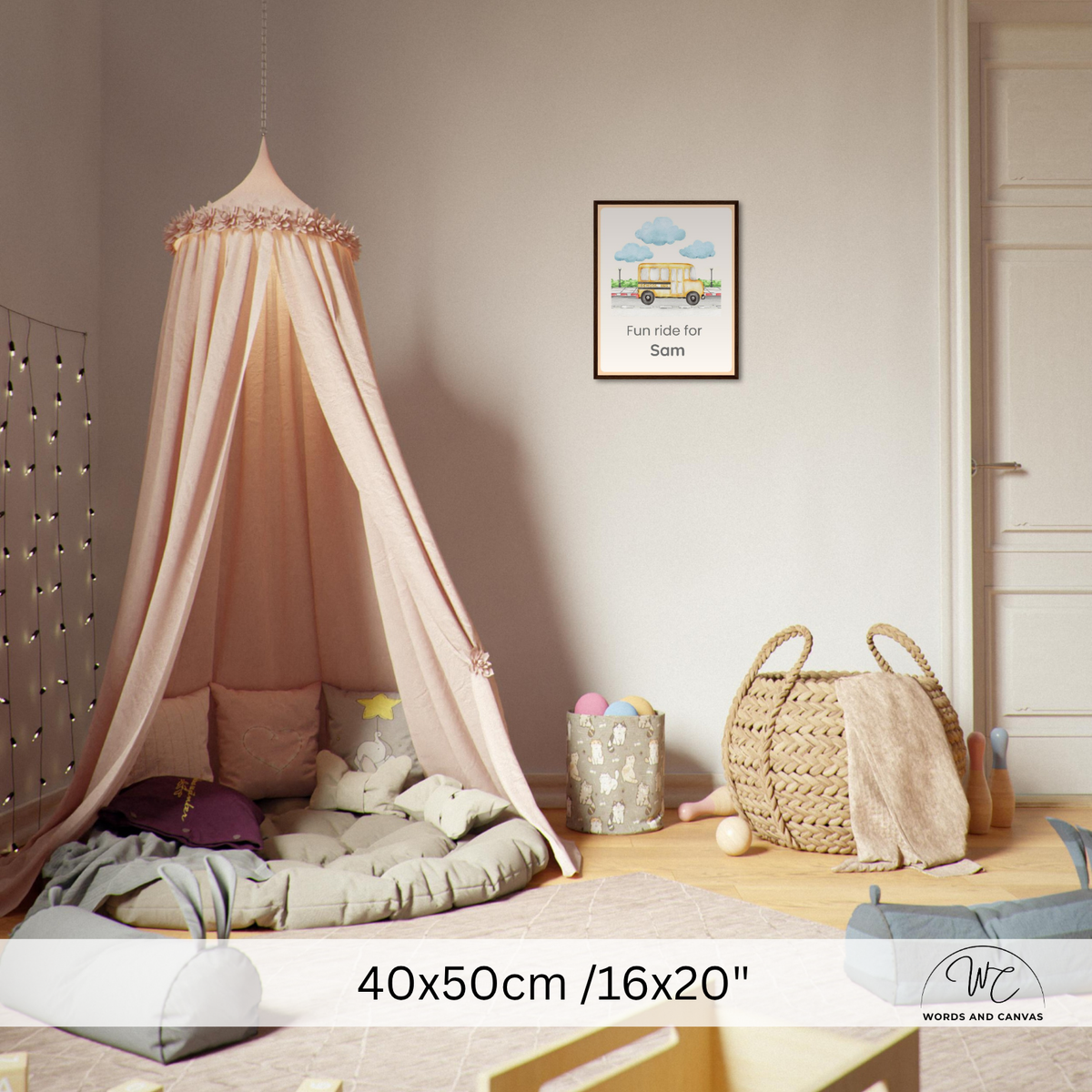 A pink canopy bed with sheer fabric draped over a mattress in a styled children's bedroom. The room includes a woven basket, a small rug, a wall hanging, and a framed print.