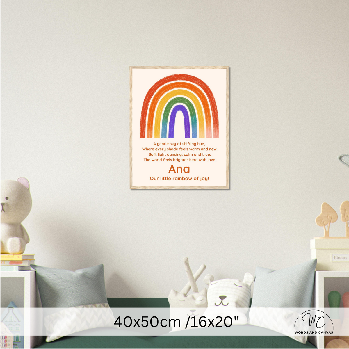 A personalized children's wall art print featuring a colorful rainbow and a poem titled 'Our little rainbow of joy' with the name 'Ana' at the bottom, displayed in a styled nursery setting above a bed.
