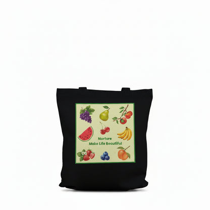 A black canvas tote bag with long shoulder straps, featuring a colorful front graphic print of various fruits (watermelon, grapes, banana, strawberries, blueberries) on a light green background with the text 'Nurture Make Life Beautiful.'.