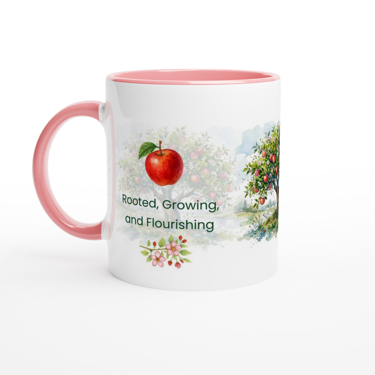 A white ceramic mug with a pink interior and handle, featuring a watercolor-style apple tree illustration and the text 'Rooted, Growing, and Flourishing' on the front.