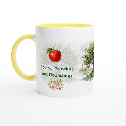 A white ceramic mug with a yellow interior and handle, featuring a watercolor-style apple tree illustration and the text 'Rooted, Growing, and Flourishing' on the front.