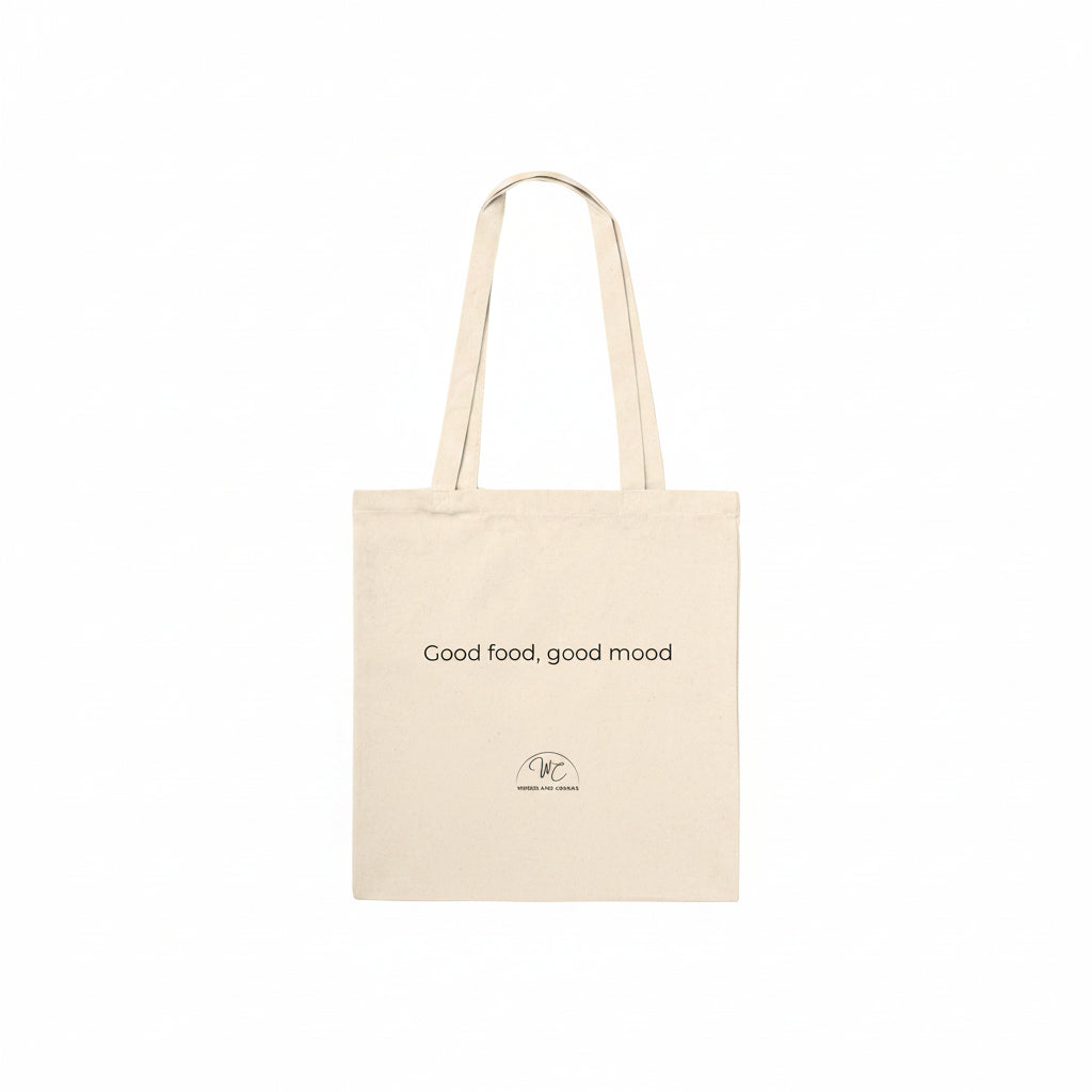 A natural canvas tote bag with two shoulder straps, featuring the printed text 'Good food, good mood' and a small circular logo near the bottom, shown against a plain white background.