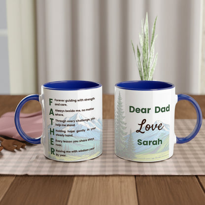 Two ceramic mugs with blue interiors and handles displayed on a wooden table. One mug shows a poem starting with 'FATHER' in green text over a mountain landscape, and the other shows 'Dear Dad Love Sarah' in green and brown text over a matching landscape.