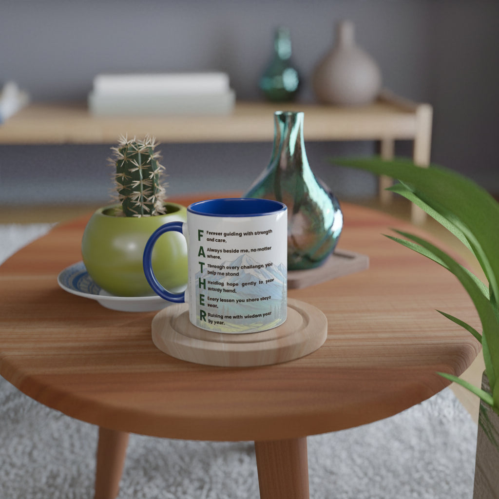 A white ceramic mug with a blue handle and rim sits on a round wooden coaster on a light wood table. The mug features a green typographic design spelling out 'FATHER' with motivational quotes.