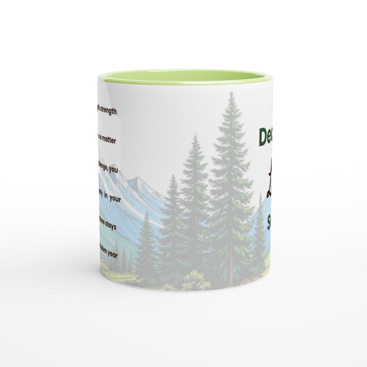 A white ceramic coffee mug with a light green interior, featuring a printed graphic of pine trees and mountains with partial text.