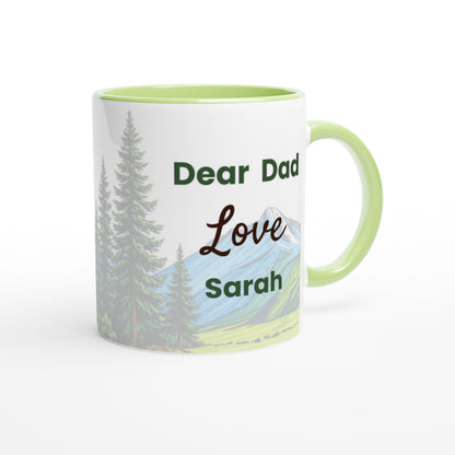 A white ceramic mug with a light green handle and interior, featuring a printed landscape design of pine trees and mountains with the text 'Dear Dad Love Sarah'.