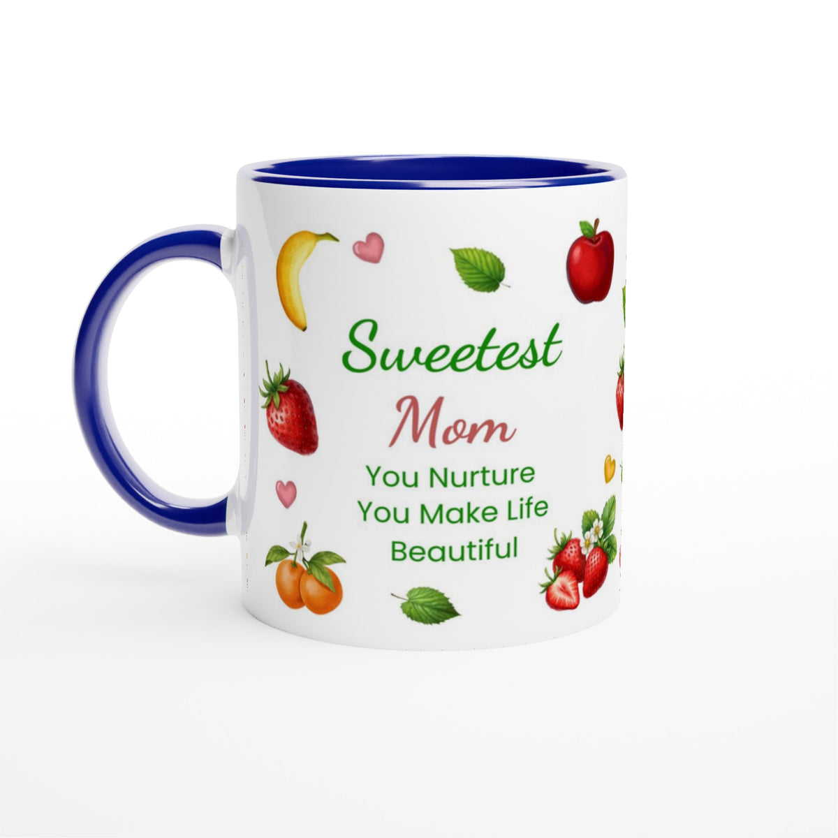 A white ceramic mug with a blue handle and blue interior, printed with the phrase 'Sweetest Mom You Nurture You Make Life Beautiful' in green and red lettering, surrounded by illustrations of fruits and strawberries.