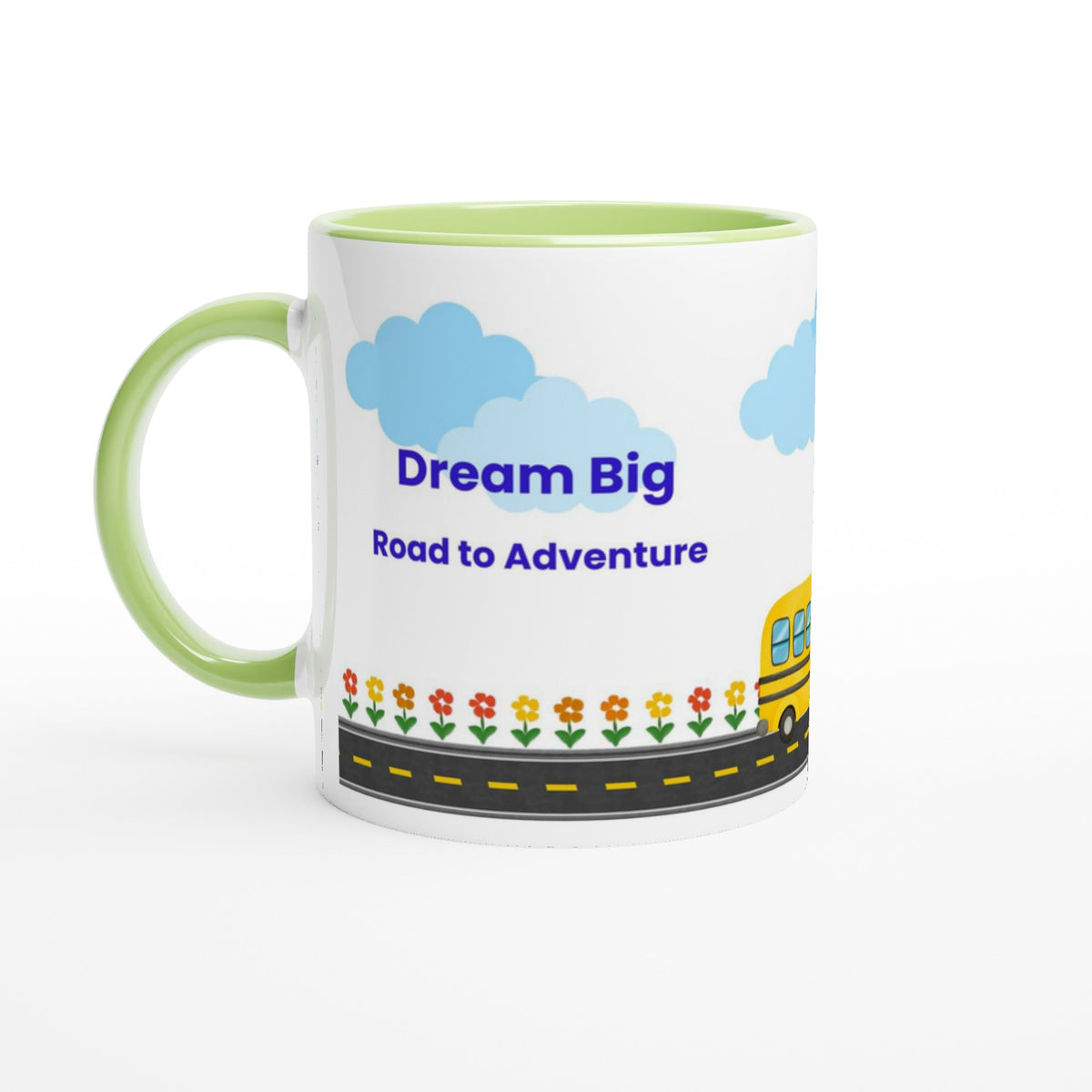 A white ceramic mug with a light green handle and interior, featuring a cartoon illustration of blue clouds, the text 'Dream Big Road to Adventures' in blue, a yellow school bus, and small flowers along a road.