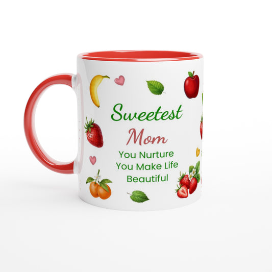 A white ceramic mug with a red handle and red interior, decorated with illustrations of fruits and the text 'Sweetest Mom You Nurture You Make Life Beautiful' on a clean white background.