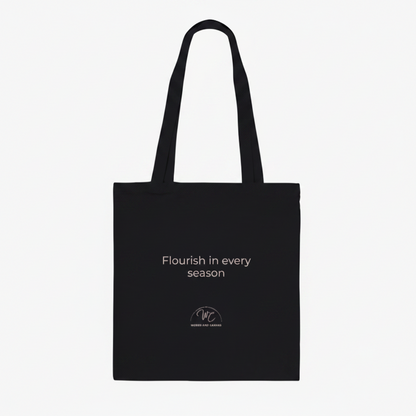 Black tote bag with personalised text on a white background