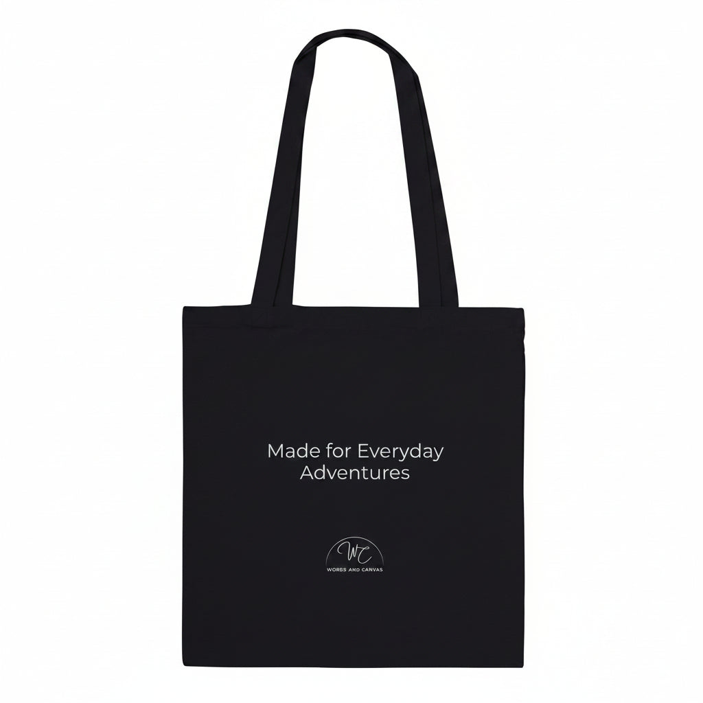 A black canvas tote bag with black printed text and a small circular logo below