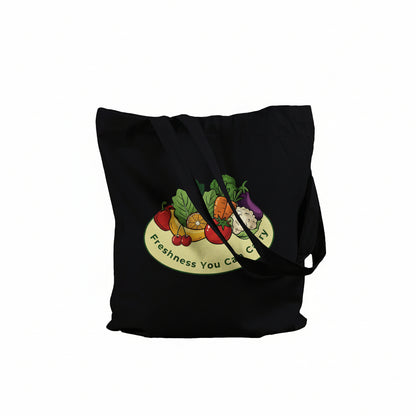 A black canvas tote bag with a colorful graphic of fresh fruits and vegetables on a yellow plate, featuring the text 'Freshness You Can Carry' on a white background.