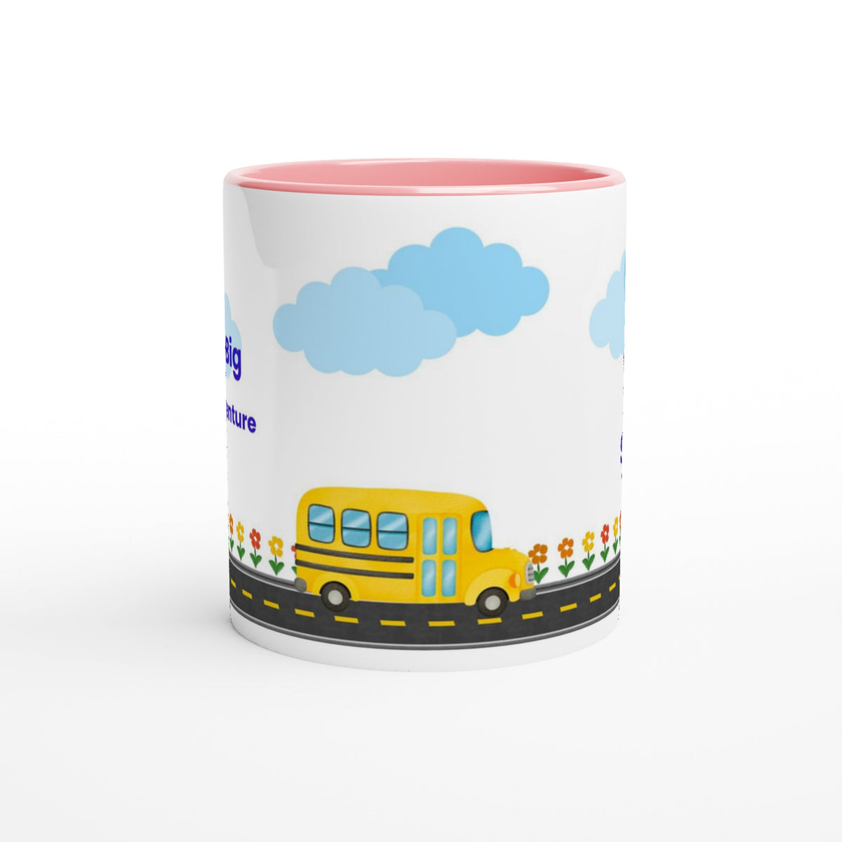 A white ceramic mug with a pink interior, featuring a cartoon illustration of a yellow school bus on a road with blue clouds and flowers.