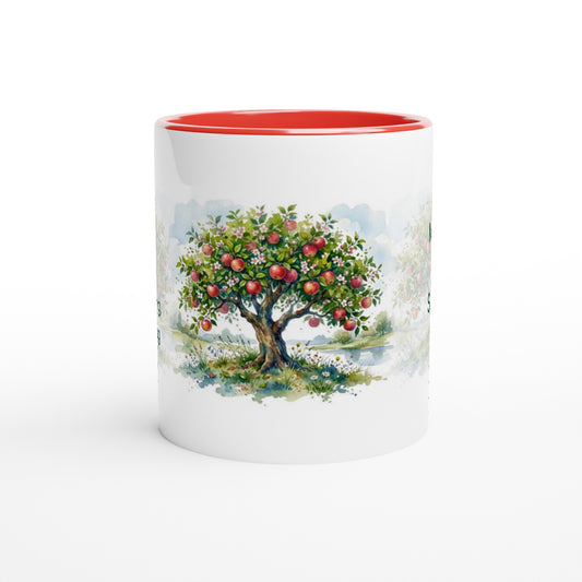 A white ceramic mug with a vibrant red interior and a printed watercolor illustration of an apple tree with red apples on the front, set against a clean white background.