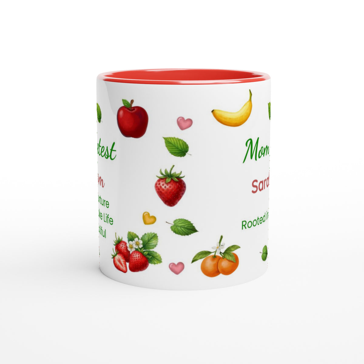 A white ceramic mug with a red interior and rim, decorated with illustrations of various fruits including strawberries, apples, oranges, and bananas, alongside green text on a white background.