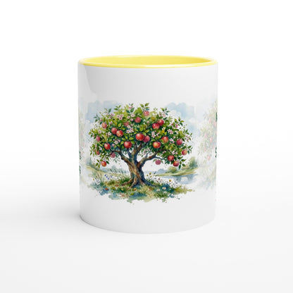 A white ceramic mug with a bright yellow interior, featuring a printed watercolor illustration of an apple tree with red apples on the front.