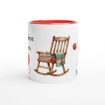 A white ceramic mug with a red interior, featuring a printed illustration of a wooden rocking chair with a green blanket and red yarn balls on a white background.