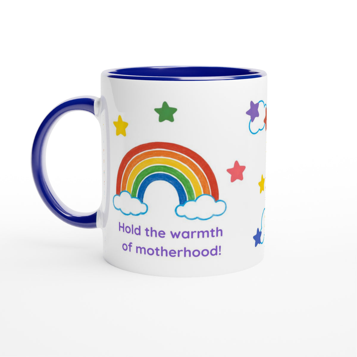 A white ceramic mug with a dark blue interior and handle, decorated with a colorful rainbow, stars, clouds, and the text 'Hold the warmth of motherhood!' in purple, shown on a clean white background.